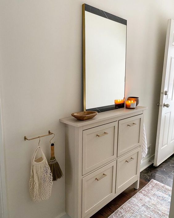 a stylish IKEA shoe cabinet hack with shaker style panels and gold handles is a lovely idea for a modern space
