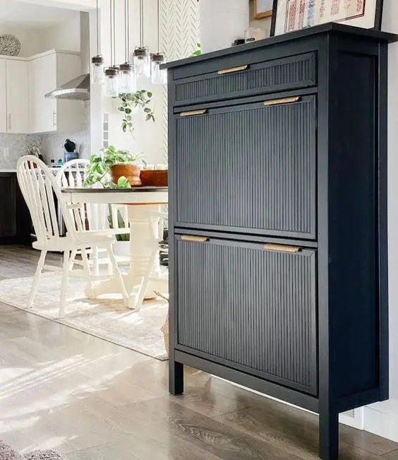 an elegant black IKEA Hemnes shoe cabinet hack with fluted panels and gold handles is a stylish idea