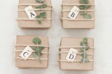 DIY neutral paper mache gift boxes with fresh sprigs and letter tags