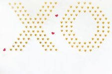 DIY chocolate XO and heart wall as a Galentine party backdrop