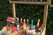 02 a prosecco bar with a chalkboard sign, prosecco, fruits and berries plus a floral centerpiece