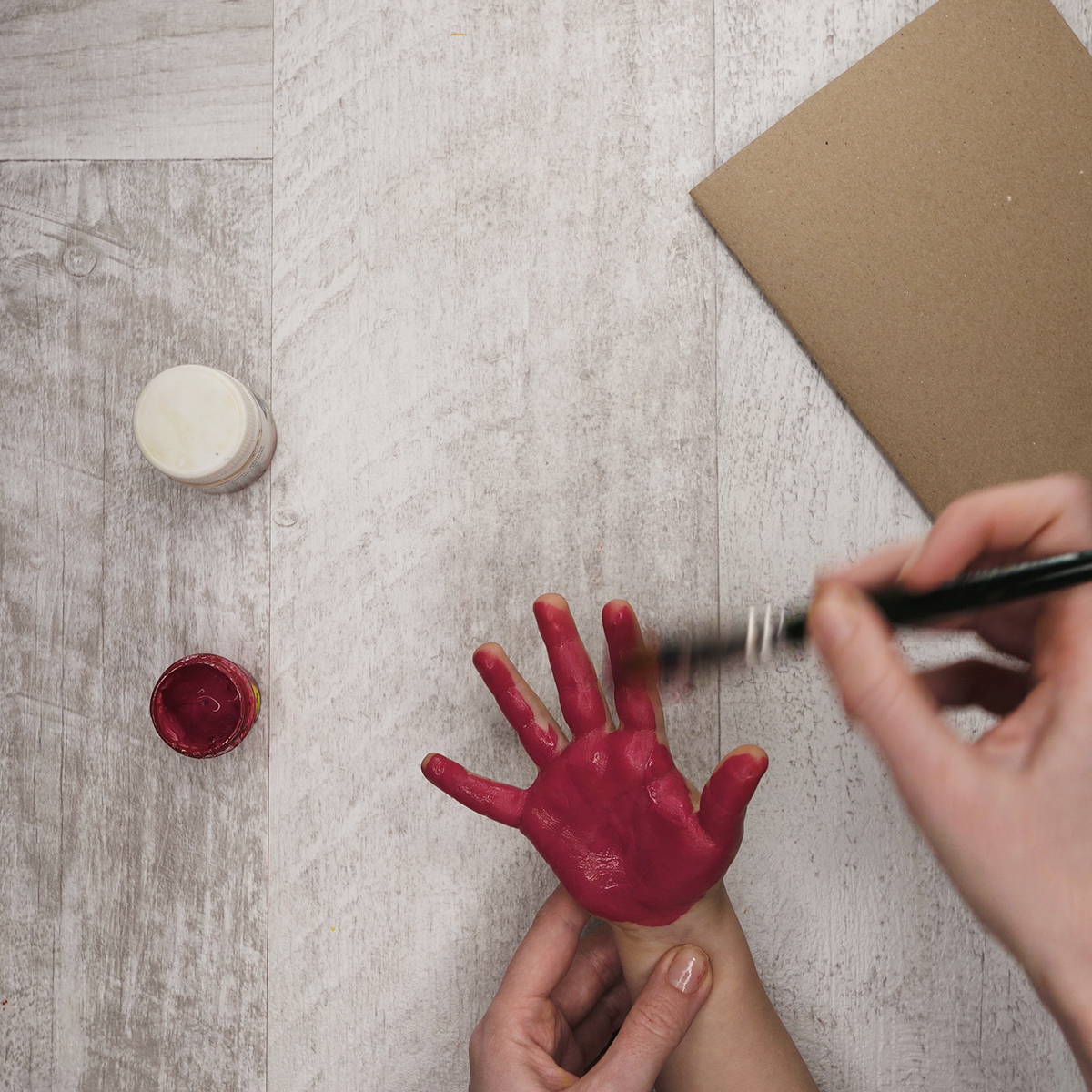 Cover your kid’s hand with fuchsia paint