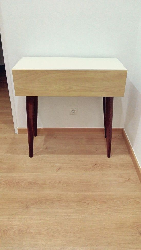 a Metod cabinet turned into a small sideboard on tall legs and with a light colored wood door