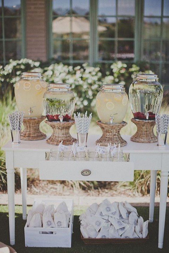 a rustic drink station of a vintage dining table, with tanks placed in baskets and a drawer with jars