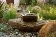 13 a rock fountain of two parts plus large pebbles around looks very natural and adds appeal to the space