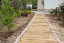 16 a wooden walkway with a stone border is a cool rustic idea for many outdoor spaces and is easy to construct
