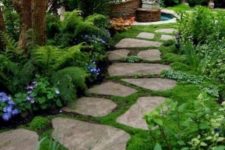 23 a stone front yard pathway with moss in between and around for a welcoming and beautiful space