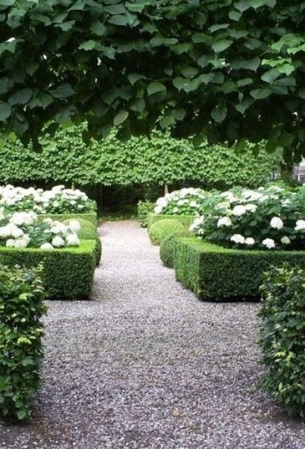 a formal or classic garden with gravel pathways   gravel is a cool idea for such a garden with large paths