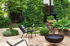 a stylish modern backyard done with gravel and stone, with metal chairs, a fire put, some greenery around is cool