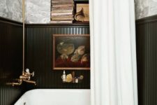 04 an elegant black and white bathroom with a vintage black clawfoot bathtub plus a black and white curtain