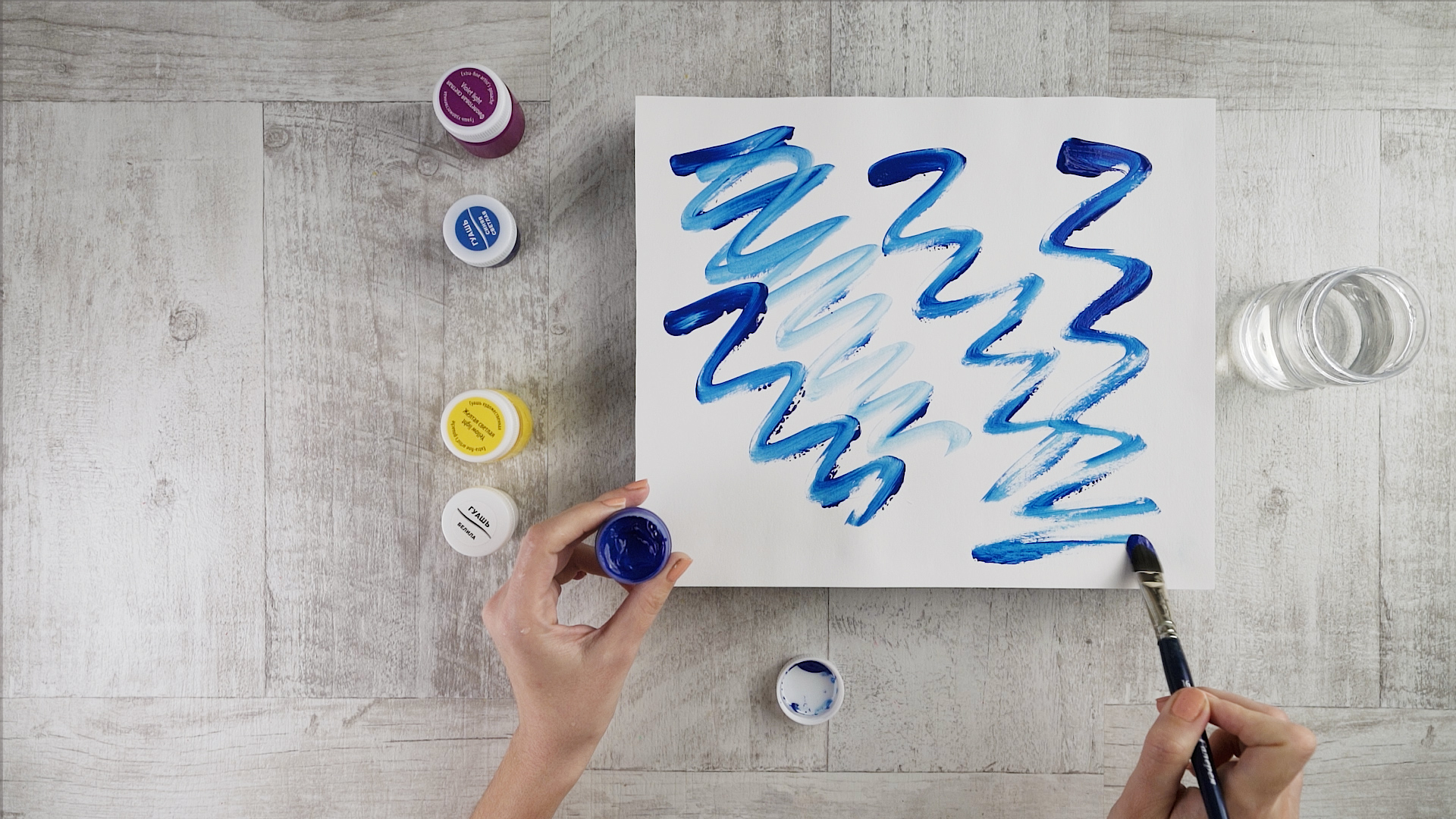 Take blue paint and paint some waves on the paper.