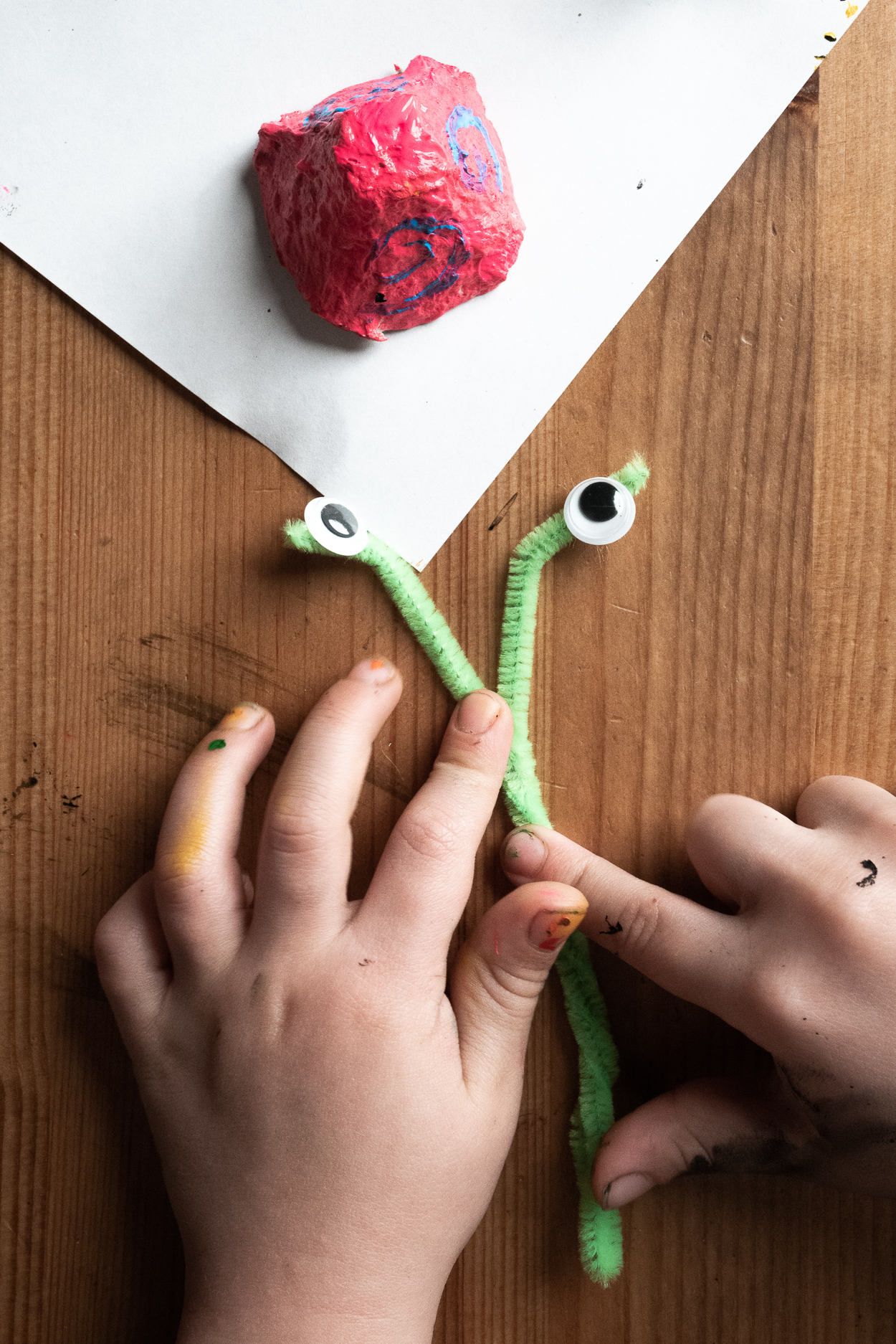 Decorate the snail piece with two green pipe cleaners and googly eyes placed on them – make two holes on the opposite sides of the snail and put the pipe cleaner through it to get eyes and a tail on the back.