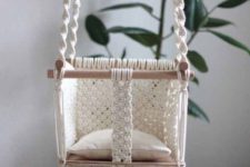 06 a macrame baby chair with long fringe and some wooden sticks is a very cute idea