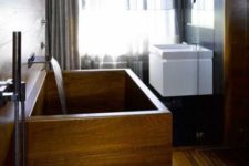 07 a contemporary rectangular wooden bathtub in a minimalist bathroom with curtains for privacy