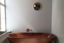 10 a large rich-stained wooden bathtub with gold fixtures makes a colorful statement in a neutral bathroom