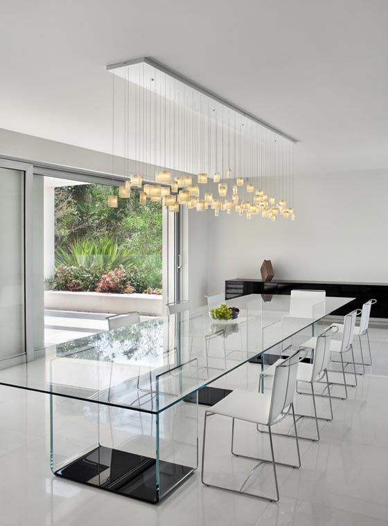 a spectacular all glass dining table with neutral and dark legs all made of glass