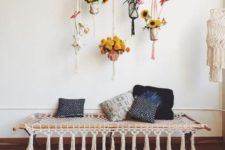 13 a macrame daybed with tassels and macrame pot hangings are perfect for a boho space