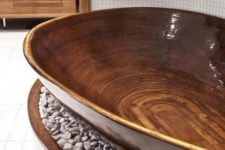 13 a relaxing polished wood bathtub placed on a platform with pebbles brings ultimate relaxation