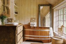 rustic bathroom design with a wooden tub