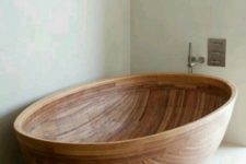 15 a wooden bathtub shaped as a beautiful half coconut shell will fit any contemporary or minimalist bathroom