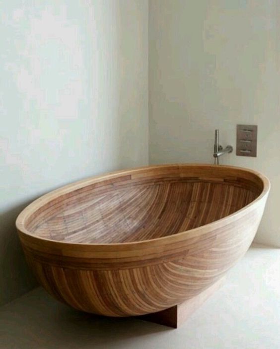 a wooden bathtub shaped as a beautiful half coconut shell will fit any contemporary or minimalist bathroom