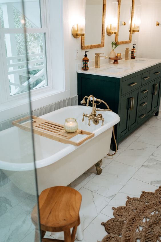 a farmhouse bathroom with white marble tiles, a soto vanity, a clawfoot tub, a jute rug and a shower space plus a wooden stool