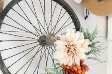 DIY old bike wheel wreath with fake blooms