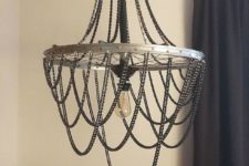 DIY industrial chandelier of a bike wheel with chains