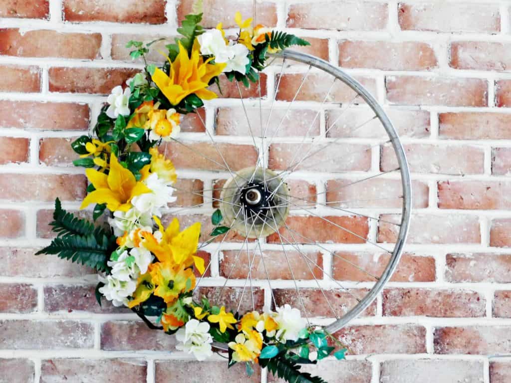 DIY colorful bike wheel wreath with fake blooms