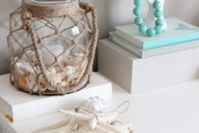 05 a twine wrapped lantern with seashells and a candle in the center feels very coastal and inspiring