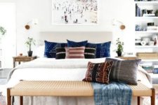 14 a wicker bench matches the boho chic bedroom abd adds texture to the space