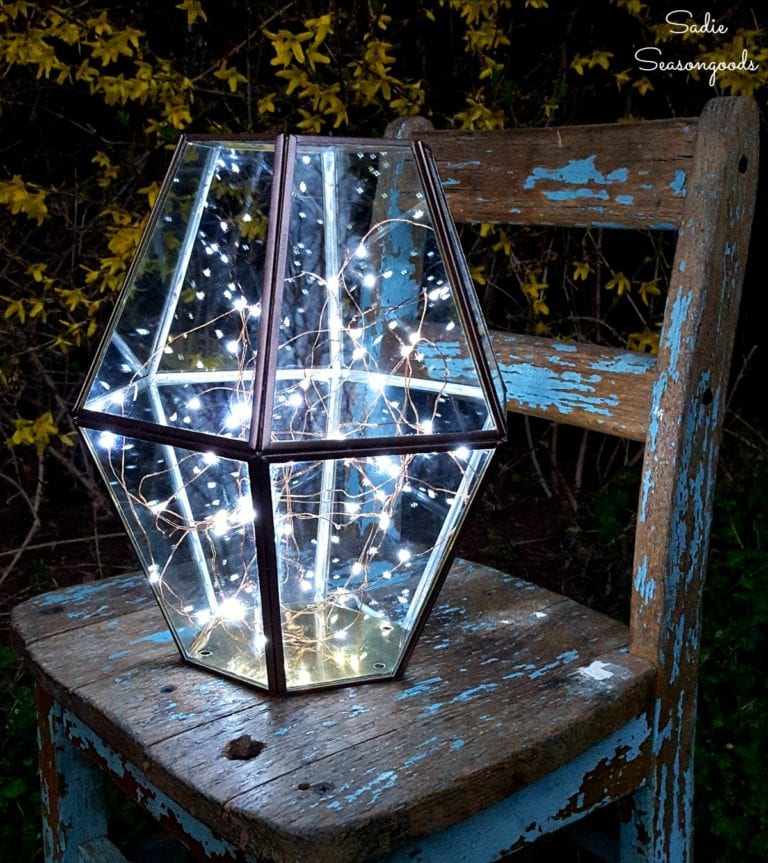 DIY firefly light of a metal hurricane and lights (via www.sadieseasongoods.com)