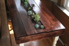 07 a stained pallet side table with a planter in the center and lots of succulents growing is a fresh rustic idea