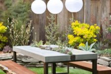 09 a concrete dining table with a planter in the center and succulents and greenery growing is very chic and trendy