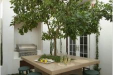 13 an outdoor dining table of concrete wth a real tree growing in the center will refresh any tiny patio