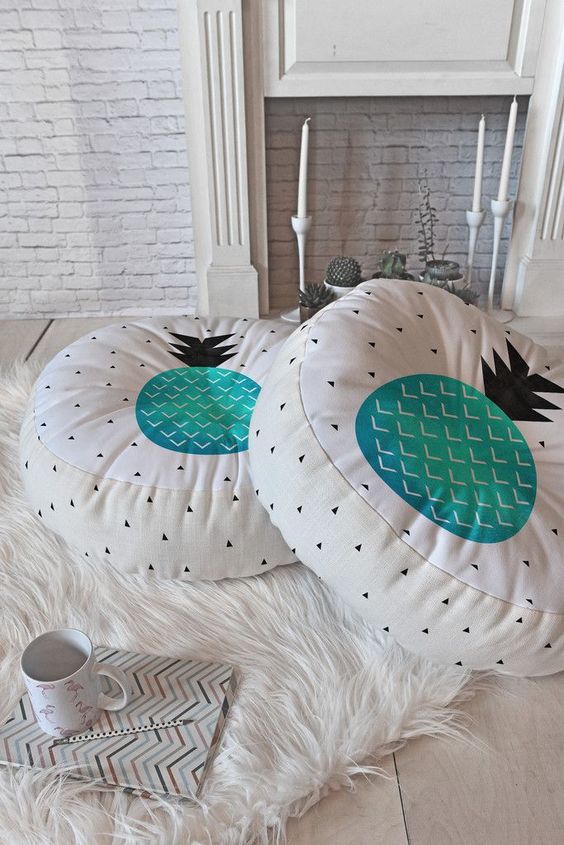 bright floor cushions with turquoise pineapples on top and geometric patterns