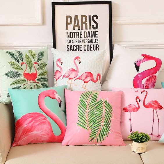 an arrangement of bright flamingo and tropical leaf pillows will bring a summer feel to the space