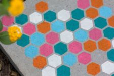 DIY concrete stepping stones with colorful hexagons on top