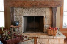 02 a rough stone fireplace with a rough wood mantel for creating a cozy rustic feel in the living room