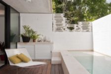 04 a minimalist pool deck with a comfy lounger and pillows and potted plants – you won’t need more to relax