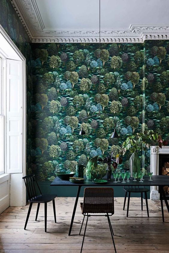 a moody dining room with dak botanical wallpaper and black furniture looks unusual and refined