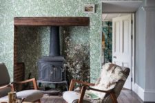 09 a cozy living room with green and white botanical wallpaper, a vintage hearth and grey chairs
