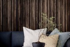 a rough wood statement wall will add texture to the space and highlight its moody ambience