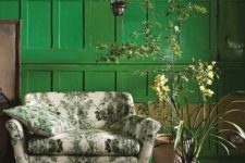 10 a botanical love seat on wooden legs in front of an emerald wall is a gorgeous idea