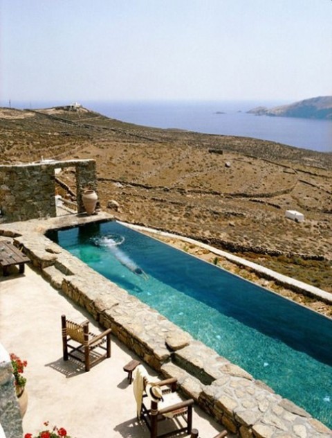 a natural terrace with a view and a long narrow pool clad with stone feels very Mediterranean