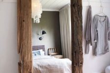 14 an oversized mirror with rough wooden frames is a great piece for a rustic and boho space