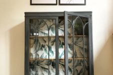 14 upgrade a vintage glass cabinet with graphite grey paint and botanical leaf print on the back