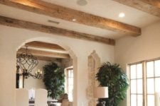 15 rough wooden beams on the ceiling highlight the cozy vintage-inspired style of the room