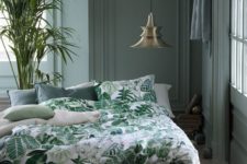 18 a moody grey bedroom with a botanical bedding set and a large plant in a pot is a stylish idea