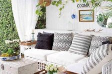 18 an eclectic pool cabana in white, with a shiplap wall, greenery, baskets, chic coffee tables and a rattan sofa with pillows